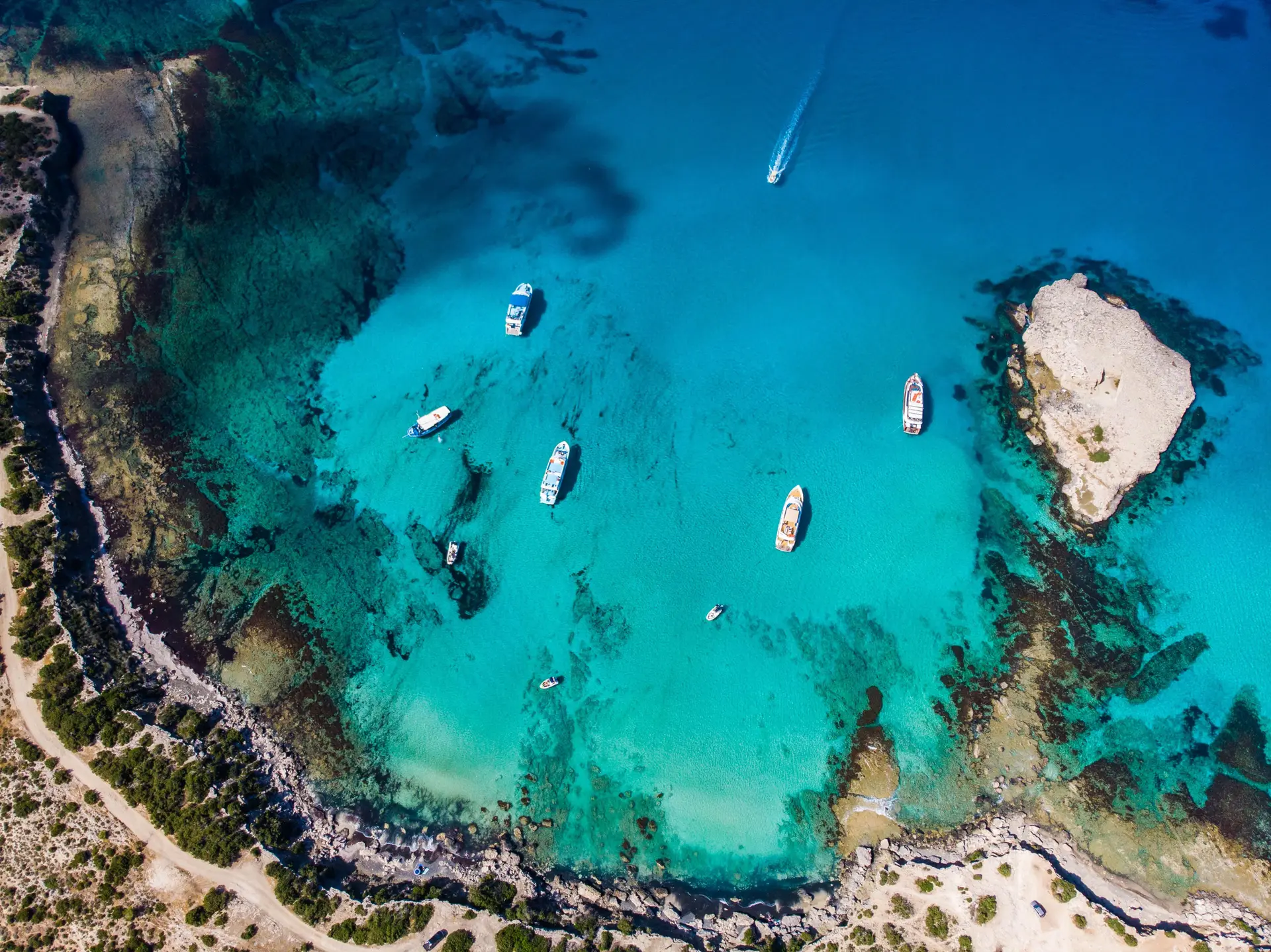 Aerial view of the Blue Lagoon in Cyprus, turquoise water surrounded by rocky coastline